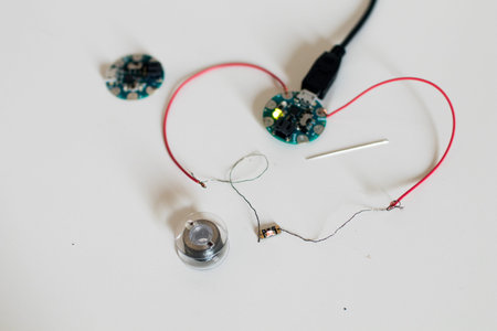 Prototype of a wearable device with a home-made sewable microcontroller, conductive wire and led...