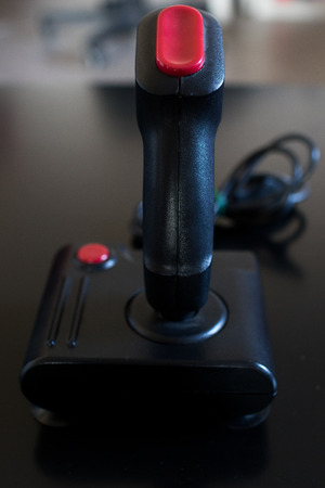 vintage 80s joystick with black handle and red button. Videogame arcade vintage accessoriesの写真素材