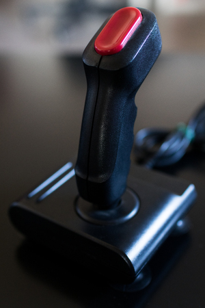 vintage 80s joystick with black handle and red button. Videogame arcade vintage accessoriesの写真素材