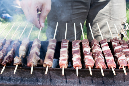 Skewers of sheep are roasted during a barbecue in the garden in summer. Arrosticini in abruzzo, typical dishの写真素材