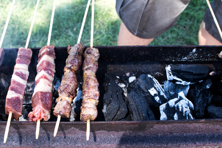 Skewers of sheep are roasted during a barbecue in the garden in summer. Arrosticini in abruzzo, typical dishの写真素材