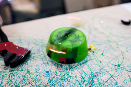 STEM Education activity with motors, feltpen, led and batteries. TRash toy robot moving with led lights spinning on top. Tinkering experienceの写真素材