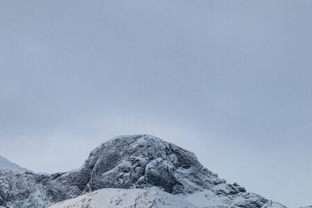 Mountain silhouette profile in arctic landscape with snow and ice. Snowy mountain on a blue sky and clouds, profile of a mountain with snow and ice. Winter landscapeの写真素材