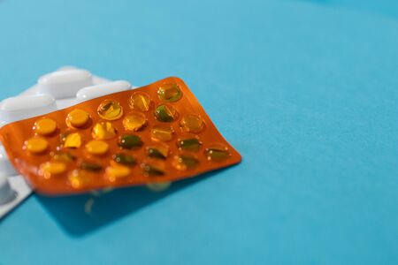 Pills blister on blue background, medicine cost for healtcare system. Pharmacy, drug modern concept. Round Pills in pack background. Package for pharmacy and medicine background. Hospital treatmentの写真素材