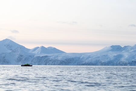 rib boat in the Arctic polar sea for excursions and whale and cetacean observation. Whale watching in the arctic in northern europe. Zodiac inflatable boat on the North Seaの写真素材