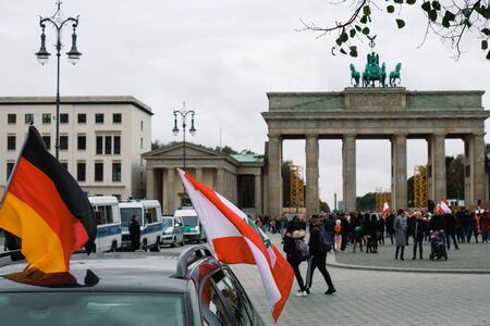 German and Lebanese flags with people protest in background,politic issues eventのeditorial素材