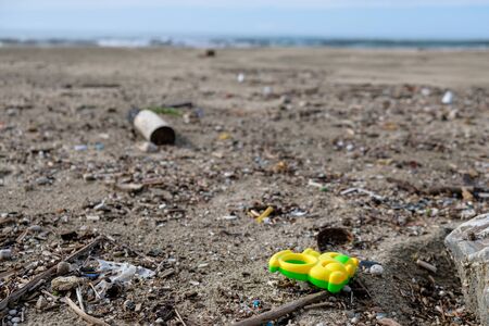 Plastic garbage on wild sea coast over blurred background,planet save conceptの写真素材