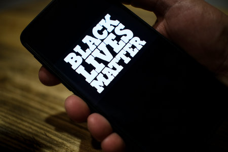 Guy use a smartphone for support black lives matter protest in usa,no racism movement