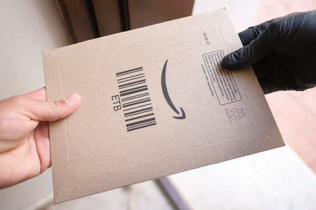 Man receive amazon prime package box as home delivery shipping,e-commerceのeditorial素材