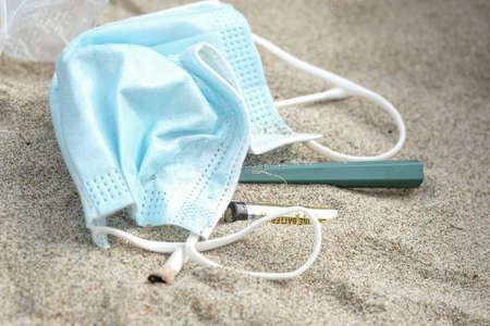 Sea pollution garbage,cotton swabs,razor blade and cigarettes discarded on beachの写真素材