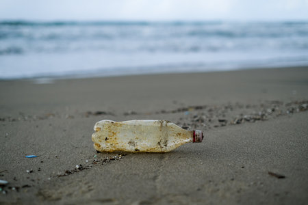 Dirty Plastic bottle waste abbandoned on sea coast ecosystem,environmental pollution contaminationの写真素材