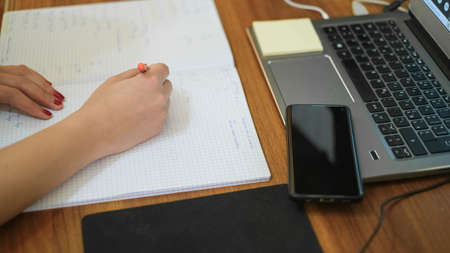 Woman studying at home while use notebook for remote schooling,covid-19 pandemic social distancingの写真素材
