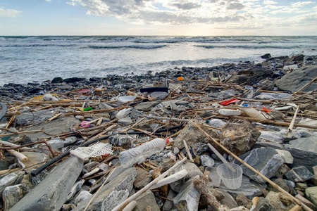 Dump of plastic garbage pollution on contaminated sea coast ecosystem,environmental wasteの写真素材