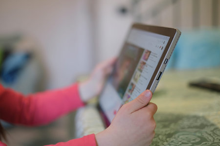Child girl use tablet for browsing cartoon video platform,kids education technology,addiction