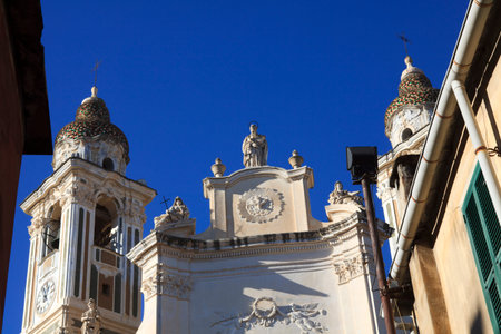 Laigueglia (SV), Italy - February 15, 2017: The bell tower and the church in Laigueglia village, Riviera dei Fiori, Savona, Liguria, Italy.のeditorial素材
