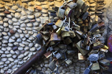 Alassio (SV), Italy - February 15, 2017: The love padlocks near the famous "Muretto" in Alassio town, Riviera dei Fiori, Savona, Liguria, Italy.のeditorial素材