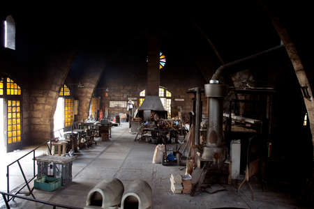Algaida Es Pla, Majorca / Spain - August 25, 2016: Handmade glass manufacturing inside factory Guardiola, Algaida Es Pla, Mallorca, Balearic Islands, Spain.のeditorial素材