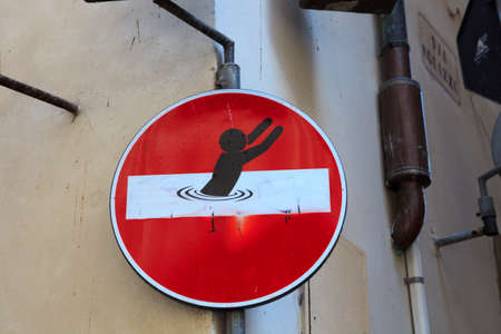 Firenze, Italy - April 21, 2017: Road sign defaced by street artist Clet Abraham, Florence, Firenze, Tuscany, Italyのeditorial素材