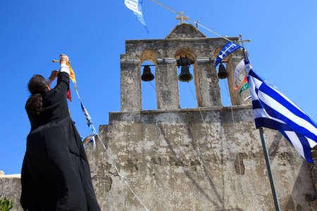 Moni, Naxos / Greece - August 23, 2014: A priest near The church of Panagia Drossiani nea Moni village, Naxos, Cyclades Islands, Greeceのeditorial素材
