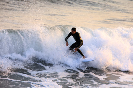 Alassio (SV), Italy - December 12, 2017: Surfer in Alassio sea, Riviera dei Fiori, Savona, Liguria,...