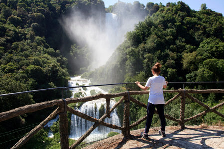 Terni (TR), Italy - May 10, 2016: A girl looks the famous Marmore waterfall, Terni, Umbria, Italy