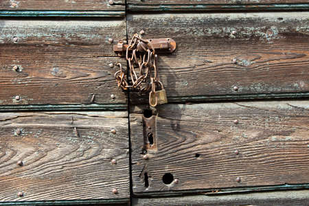 Cravegna (VCO), Italy - December 19, 2017: An old door with a lock and chain, Vigezzo Valley, VCO, Piedmon, Italyのeditorial素材