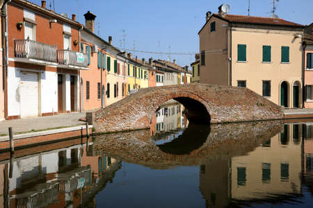 Comacchio (FE),  Italy - April 30, 2017: Houses in Comacchio village reflecting in the water, Delta Regional Park, Emilia Romagna, Italyのeditorial素材