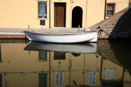 Comacchio (FE),  Italy - April 30, 2017: Houses in Comacchio village reflecting in the water, Delta Regional Park, Emilia Romagna, Italyのeditorial素材