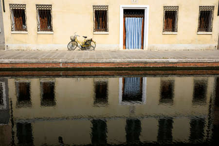 Comacchio (FE),  Italy - April 30, 2017: House in Comacchio village reflecting in the water, Delta Regional Park, Emilia Romagna, Italyのeditorial素材