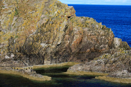 Portknockie (Scotland), UK - August 01, 2018: Coastal landscape at Bow Fiddle Rock sea arch, Portknockie, Scotland, Highlands, United Kingdomのeditorial素材