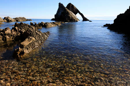 Portknockie (Scotland), UK - August 01, 2018: Bow Fiddle Rock sea arch, Portknockie, Scotland, Highlands, United Kingdomのeditorial素材