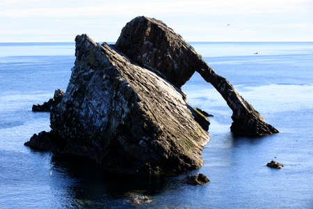 Portknockie (Scotland), UK - August 01, 2018: Bow Fiddle Rock sea arch, Portknockie, Scotland, Highlands, United Kingdomのeditorial素材