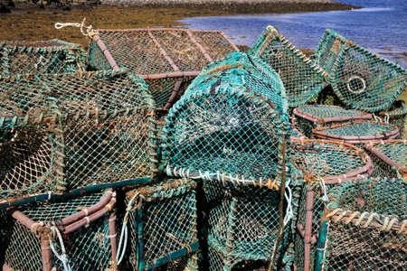 Orkney (Scotland), UK - August 10, 2018: Lobster and crab fishing pots piled in the port, Orkney, Scotland, Highlands, United Kingdomのeditorial素材