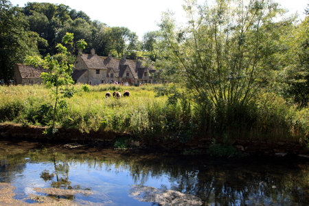 Bibury (England), UK - August 05, 2015: The river near Bibury village, Gloucestershire, England,...