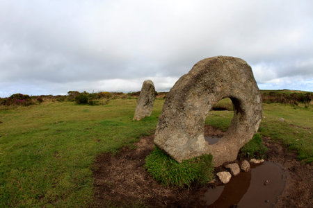 Madron (England), UK - August 16, 2015: A tourist near The famous MÃªn-an-Tol a Megalithic stone...