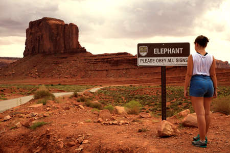 Utah/Arizona / USA - August 05, 2015: A girl looks a sign in The Monument Valley Navajo Tribal Reservation, Utah/Arizona, USAのeditorial素材
