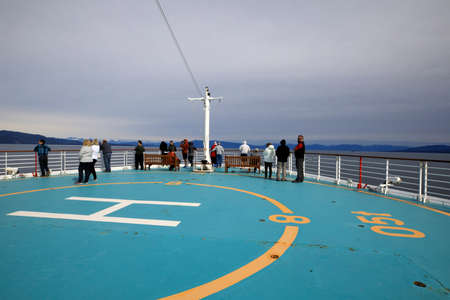 Strait Point, Alaska / USA - August 15, 2019: Tourists look the sea from helicopter deck on cruise ship, Strait Point, Alaska, USAのeditorial素材