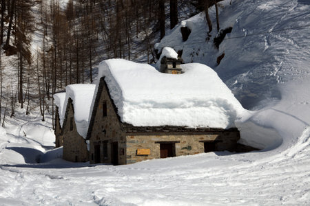 Devero Park ( Verbano-Cusio-Ossola ), Italy - January 15, 2017: Typical houses in Alpe Devero Park, Ossola Valley, VCO, Piedmont, Italyのeditorial素材