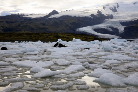 Fjallsarlon / Iceland - August 18, 2017: Fjallsarlon Glacier Lagoon view with ice formations,...