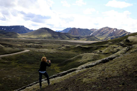 Landmannalaugar / Iceland - August 15, 2017: A tourist takes a picture near Landmannalaugar park, Iceland, Europeのeditorial素材