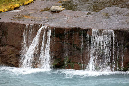 Hraunfossar / Iceland - August 15, 2017: Hraunfossar waterfalls formed by rivulets streaming out of the Hallmundarhraun lava field formed by the eruption of a volcano lying under the glacier Langjokul., Iceland, Europeのeditorial素材