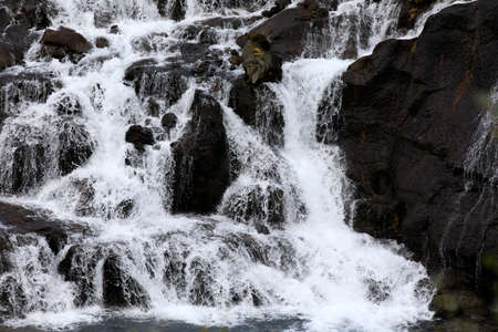 Hraunfossar / Iceland - August 15, 2017: Hraunfossar waterfalls formed by rivulets streaming out of the Hallmundarhraun lava field formed by the eruption of a volcano lying under the glacier Langjokul., Iceland, Europeのeditorial素材