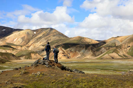 Landmannalaugar / Iceland - August 15, 2017: Tourists look the colorful mountains at Landmannalaugar park, Iceland, Europeのeditorial素材