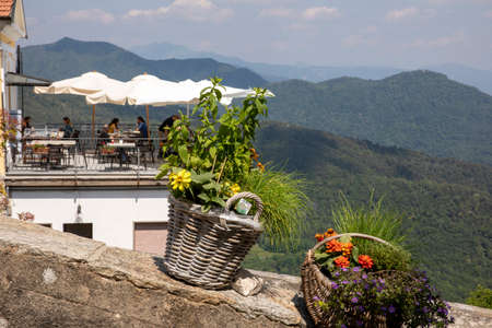Sacro Monte (VA), Italy - June 01, 2020: A basket with flowers at pilgrimage village of Santa Maria del Monte on Sacro Monte di Varese, UNESCO World Cultural Heritage Site, Santa Maria del Monte, Varese, Lombardy, Italyのeditorial素材