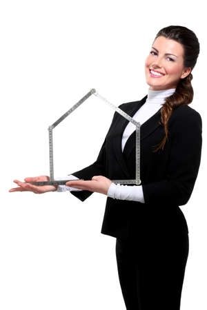 Young beautiful happy business woman house symbol on whiteの写真素材