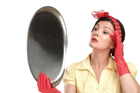 young beautiful woman housewife showing perfect washed dishes on whiteの写真素材