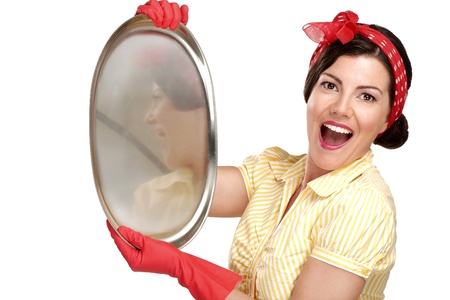 young beautiful woman housewife showing perfect washed dishes on whiteの写真素材