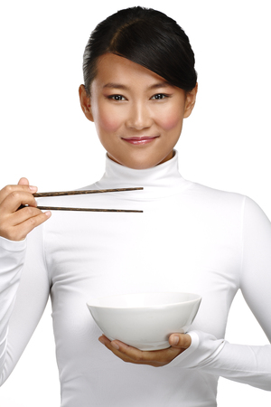 Chinese woman showing asian food using chopstick on whiteの写真素材