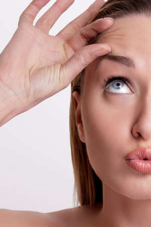 Closeup of beautiful model applying her skin treatmentの写真素材