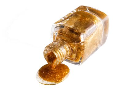 Gold nail polish drop  on whiteの写真素材